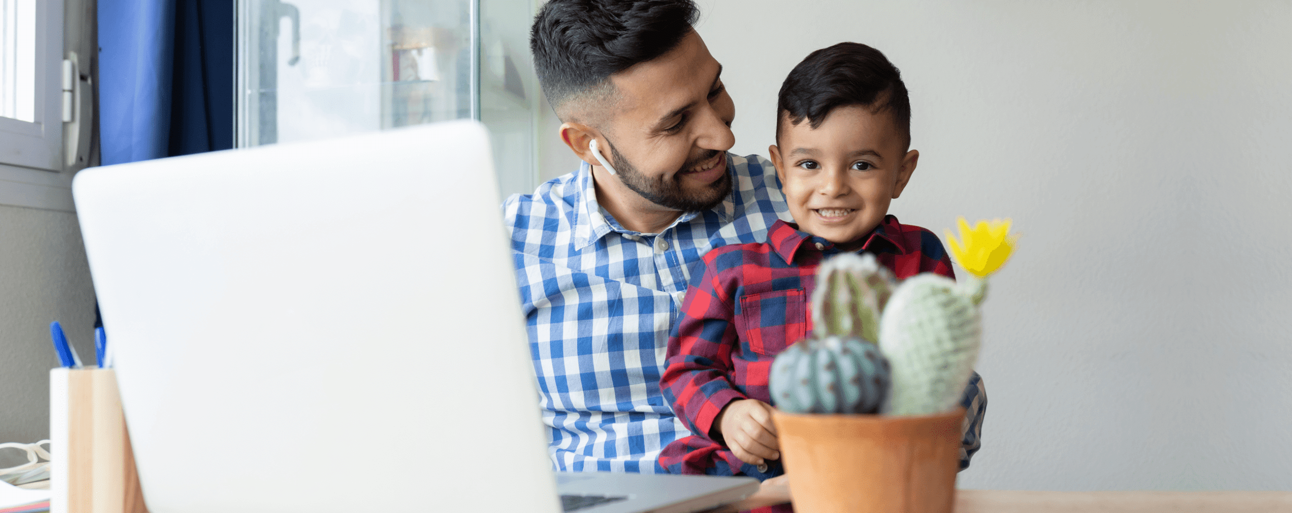 a parent helping his son in online schooling